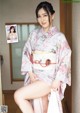 A woman in a kimono is posing for a magazine.