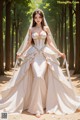 A woman in a wedding dress standing in the woods.