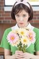 A woman holding a bunch of flowers in her hands.